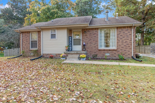 single story home featuring a front lawn