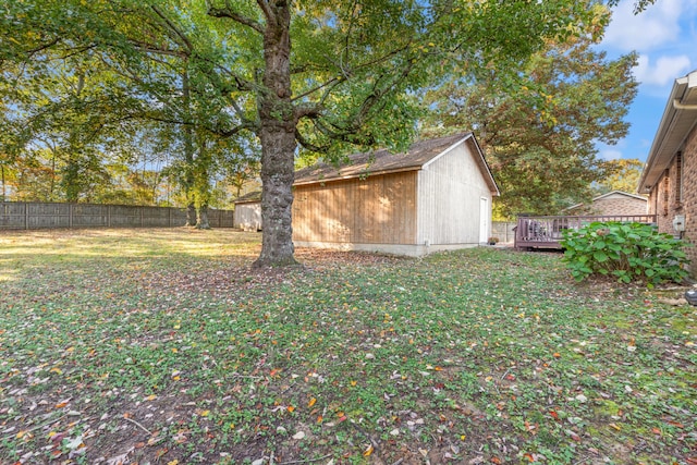 view of yard with a storage shed and a deck