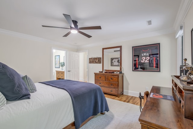 bedroom with ceiling fan, crown molding, ensuite bath, and light hardwood / wood-style floors