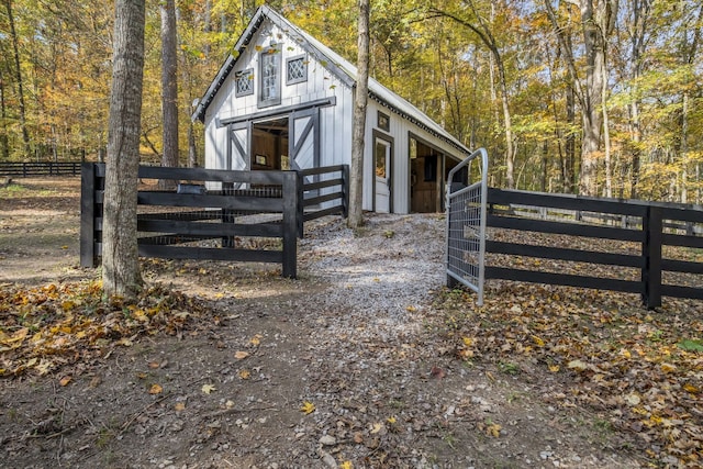 view of side of home featuring an outbuilding