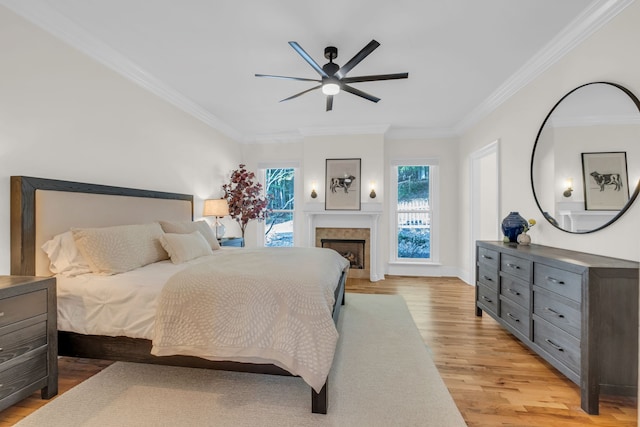 bedroom featuring crown molding, light hardwood / wood-style flooring, and ceiling fan