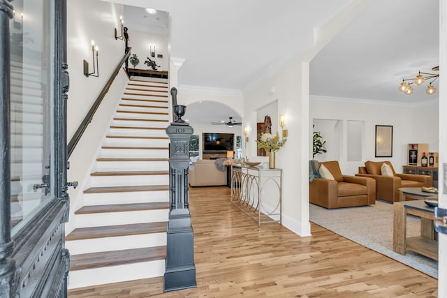 entrance foyer with hardwood / wood-style floors, crown molding, and ceiling fan