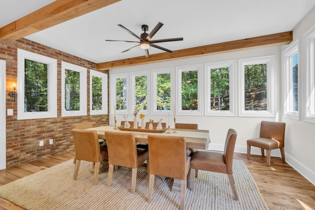 sunroom / solarium with beam ceiling, a healthy amount of sunlight, and ceiling fan