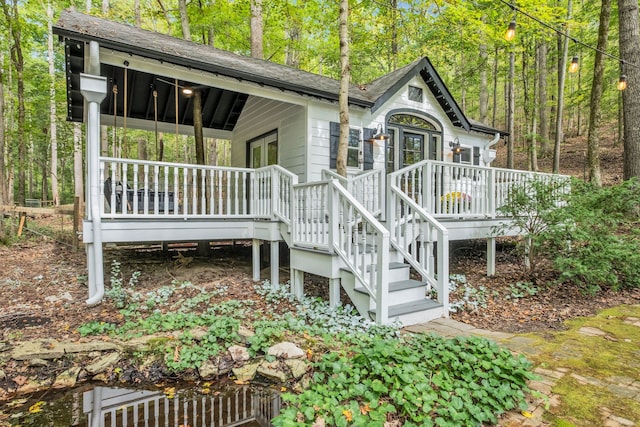 view of side of property with a wooden deck and ceiling fan