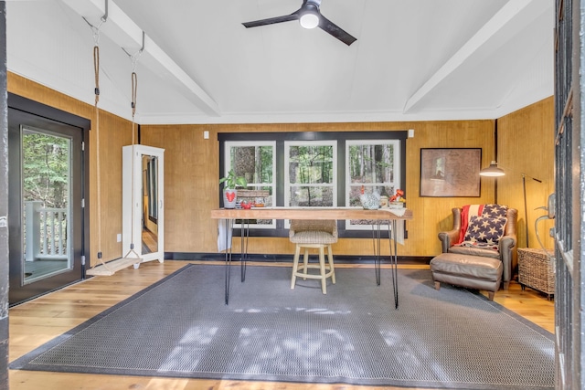 sunroom featuring beamed ceiling and ceiling fan