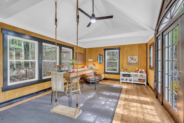 sunroom / solarium with ceiling fan and lofted ceiling with beams