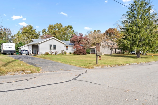 view of front of property featuring a front yard and a garage