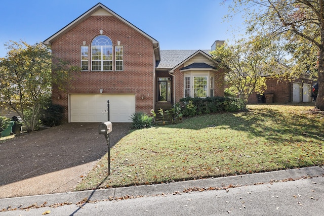 front of property with a front lawn and a garage