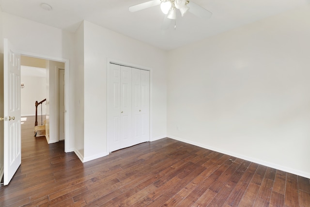 unfurnished bedroom featuring dark wood-type flooring, ceiling fan, and a closet