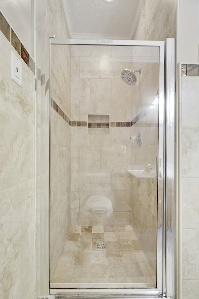 bathroom featuring ornamental molding, toilet, and walk in shower