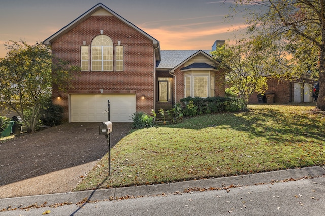 view of property featuring a yard and a garage