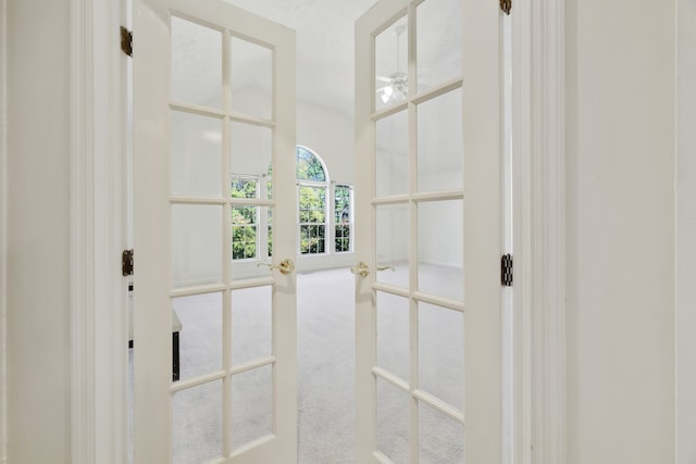 doorway to outside featuring french doors and carpet floors