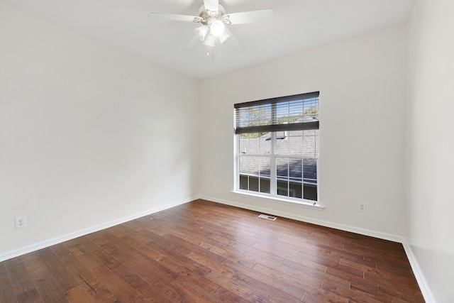 empty room featuring ceiling fan and dark hardwood / wood-style flooring