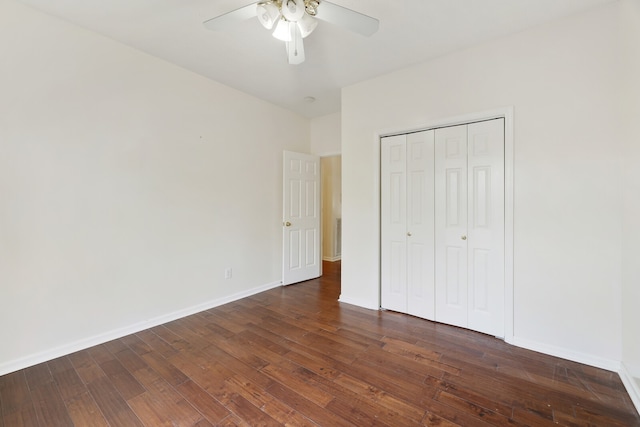 unfurnished bedroom featuring dark wood-type flooring, a closet, and ceiling fan