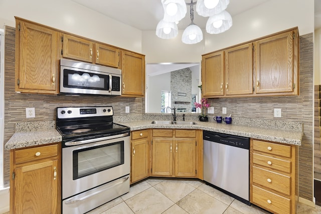 kitchen with appliances with stainless steel finishes, decorative backsplash, and sink