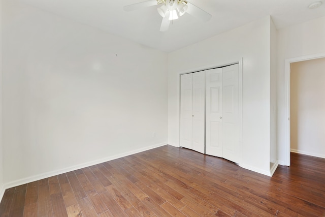 unfurnished bedroom with a closet, ceiling fan, and dark hardwood / wood-style flooring