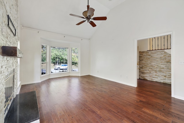 unfurnished living room featuring dark wood-type flooring, ceiling fan, high vaulted ceiling, and a fireplace