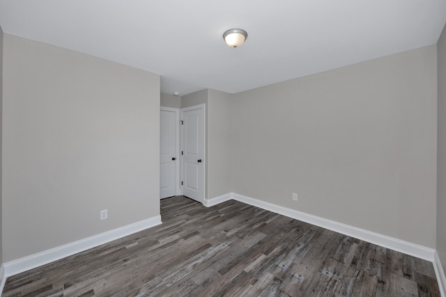 empty room with dark wood-type flooring