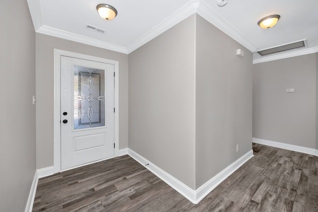 foyer with ornamental molding and dark hardwood / wood-style floors