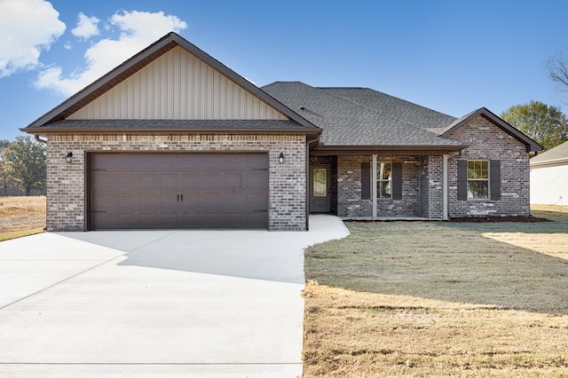 view of front of property with a front yard and a garage