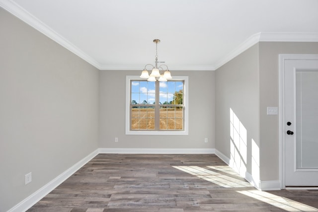 unfurnished dining area with crown molding, hardwood / wood-style flooring, and a chandelier