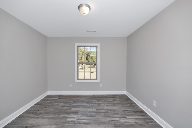 unfurnished room featuring dark wood-type flooring