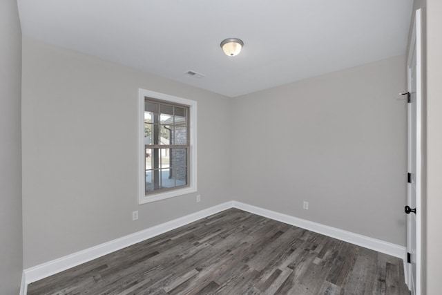 empty room with dark wood-type flooring