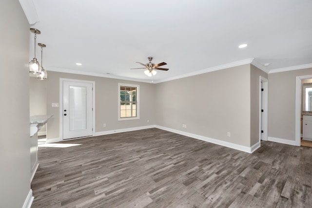 unfurnished living room featuring crown molding, dark hardwood / wood-style floors, and ceiling fan