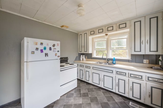 kitchen featuring white appliances, crown molding, sink, and white cabinets