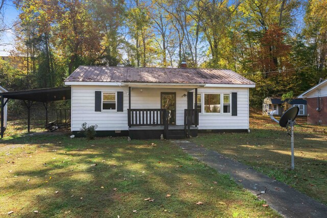 view of front of house with a carport, a front yard, and a porch