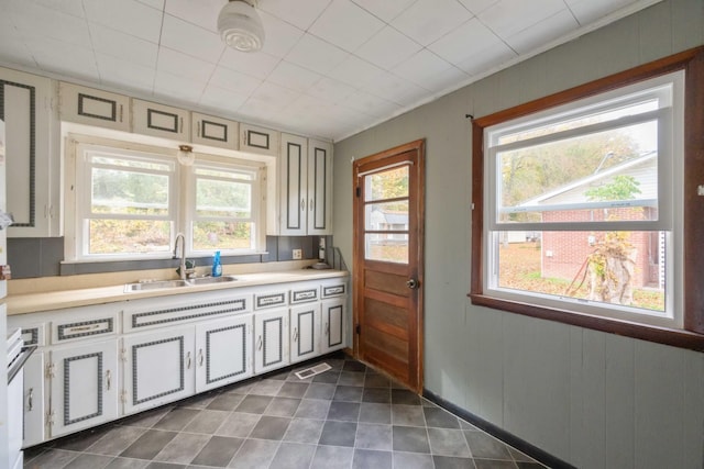 122 Shelton St, Linden, TN 37096 - kitchen with plenty of natural light, light countertops, dark tile patterned flooring, crown molding, and white cabinets
