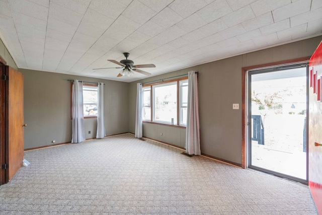 carpeted spare room with ceiling fan