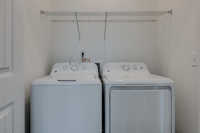 clothes washing area featuring washer and dryer