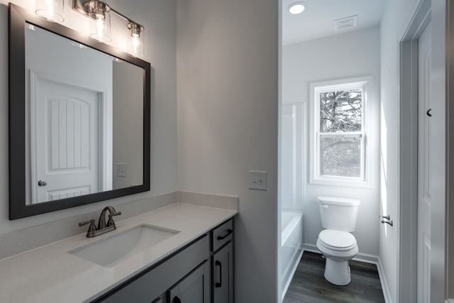 bathroom with vanity, toilet, and wood-type flooring