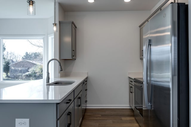 kitchen with gray cabinets, sink, stainless steel appliances, and dark wood-type flooring