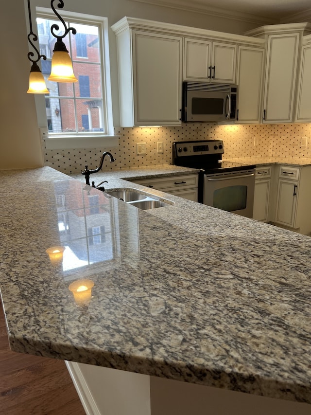 kitchen featuring dark hardwood / wood-style floors, light stone countertops, stainless steel appliances, and sink