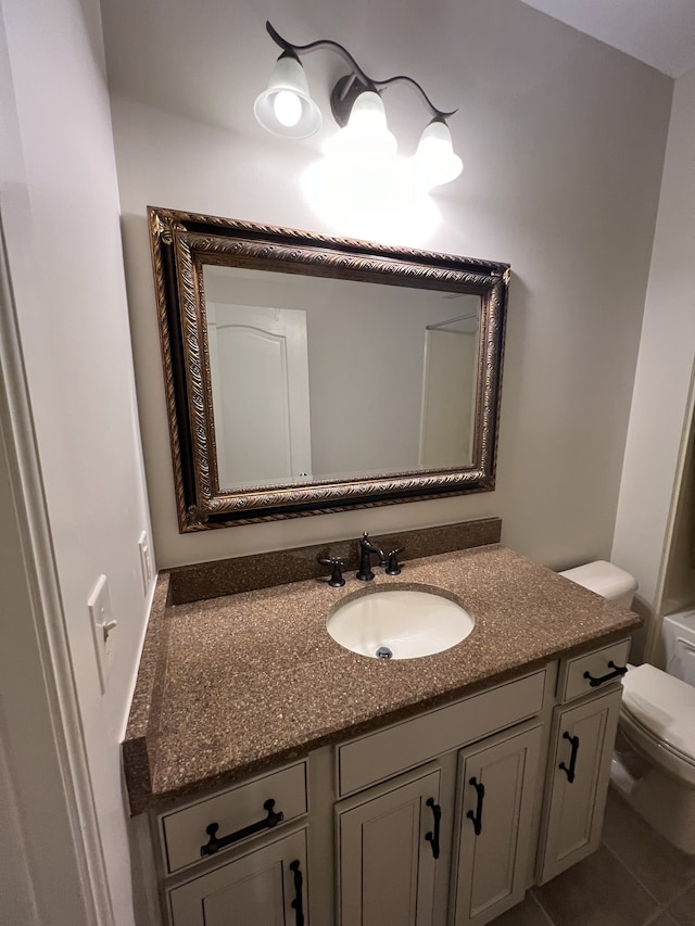 bathroom featuring vanity, toilet, and tile patterned floors