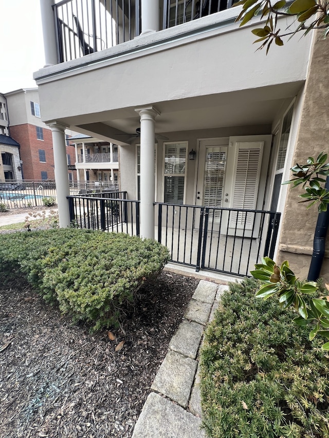 view of exterior entry with a balcony