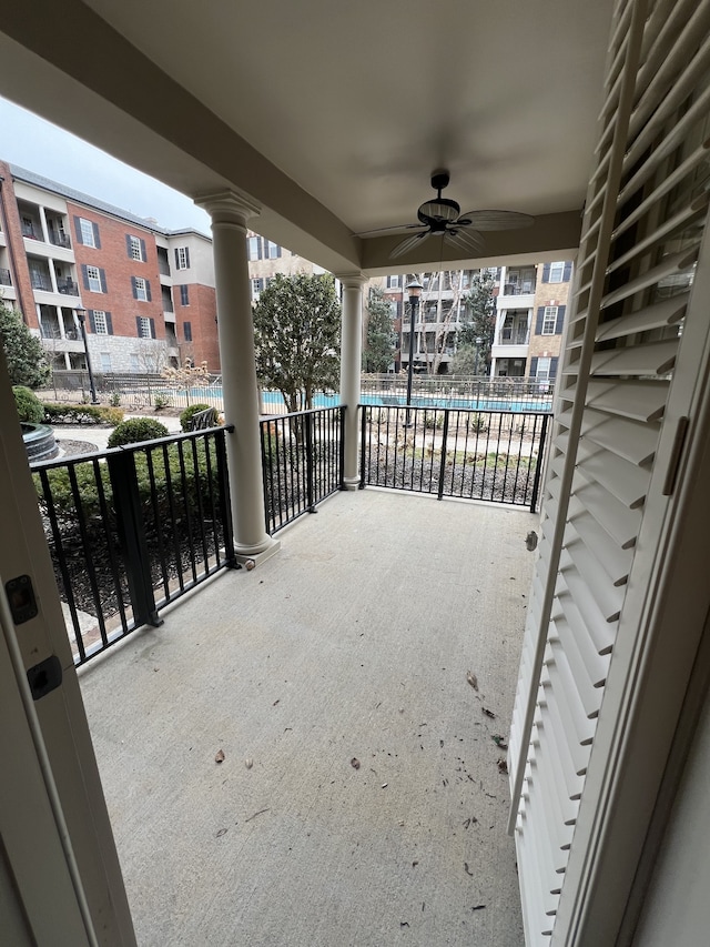 view of patio with a balcony and ceiling fan