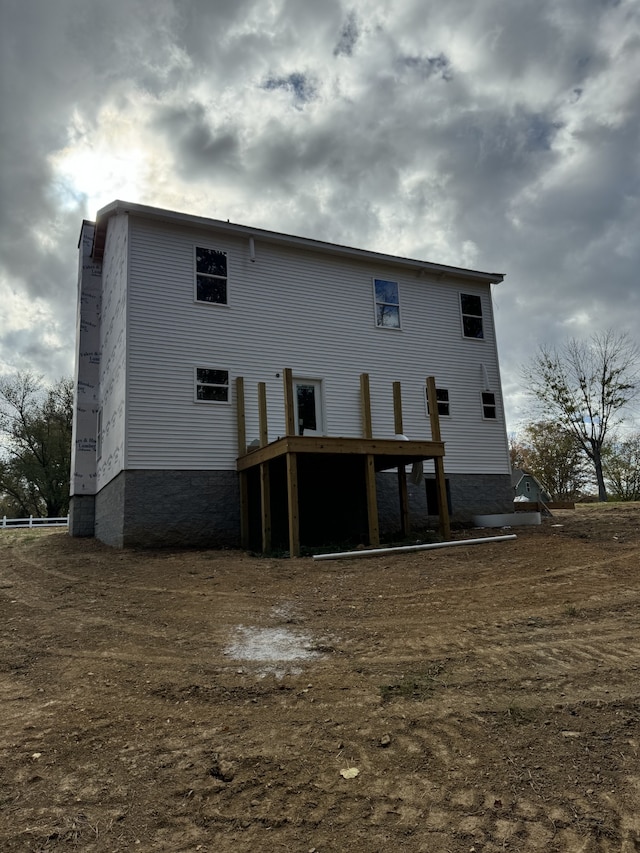 rear view of house featuring a deck