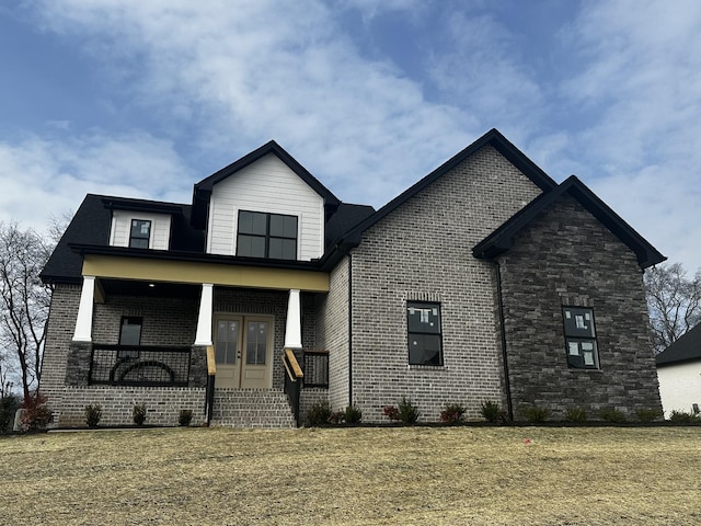 view of front of house featuring a porch and a front yard