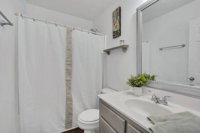 bathroom featuring vanity, hardwood / wood-style floors, a shower with shower curtain, and toilet