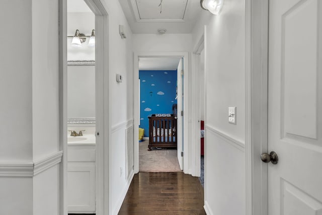 hallway featuring dark hardwood / wood-style floors and sink