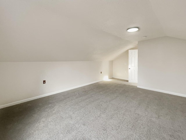 bonus room with carpet and vaulted ceiling