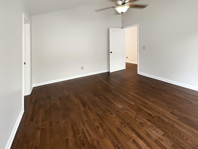 empty room with dark hardwood / wood-style floors and ceiling fan