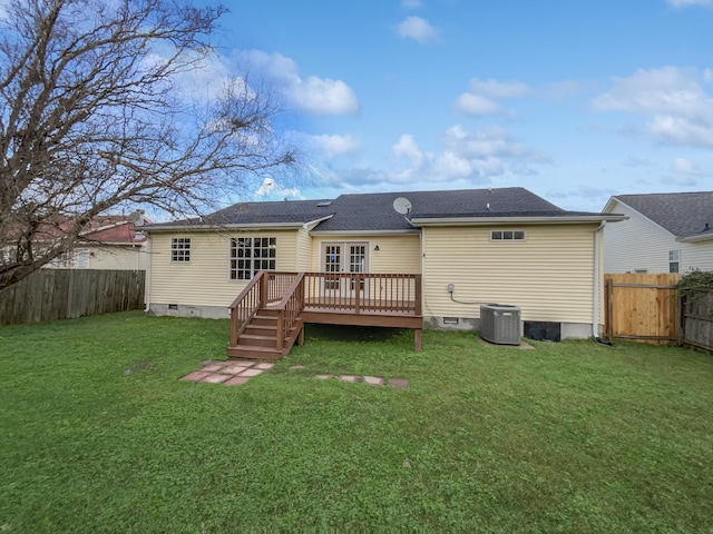 rear view of house featuring a lawn, a deck, and central AC