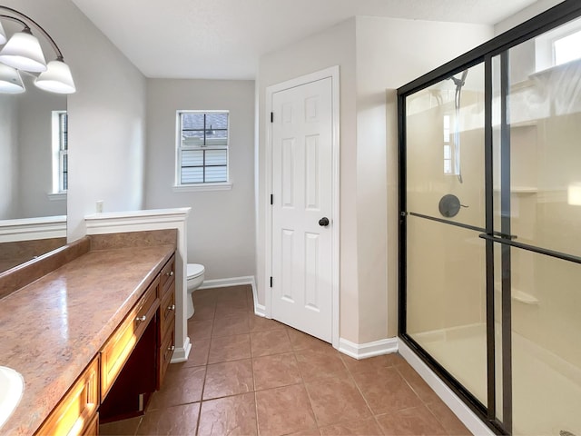 bathroom with tile patterned flooring, vanity, toilet, and walk in shower