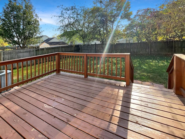 wooden terrace with a yard and central AC unit