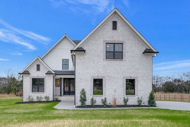 view of front of property featuring a front yard and french doors