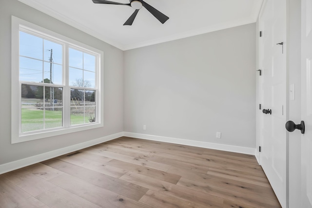 unfurnished room with a healthy amount of sunlight, light hardwood / wood-style floors, and crown molding